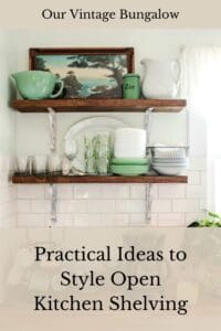 open kitchen shelving with assorted glass dish ware and vintage framed picture