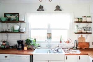farmhouse bungalow kitchen with open kitchen shelves displaying dried goods and dish ware