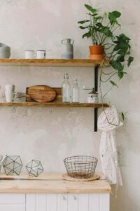 open shelving showcasing a potted plant wood metal glass and porcelain items