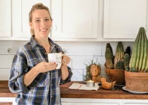 woman holding coffee mug standing in front of farmhouse butlers pantry countertop