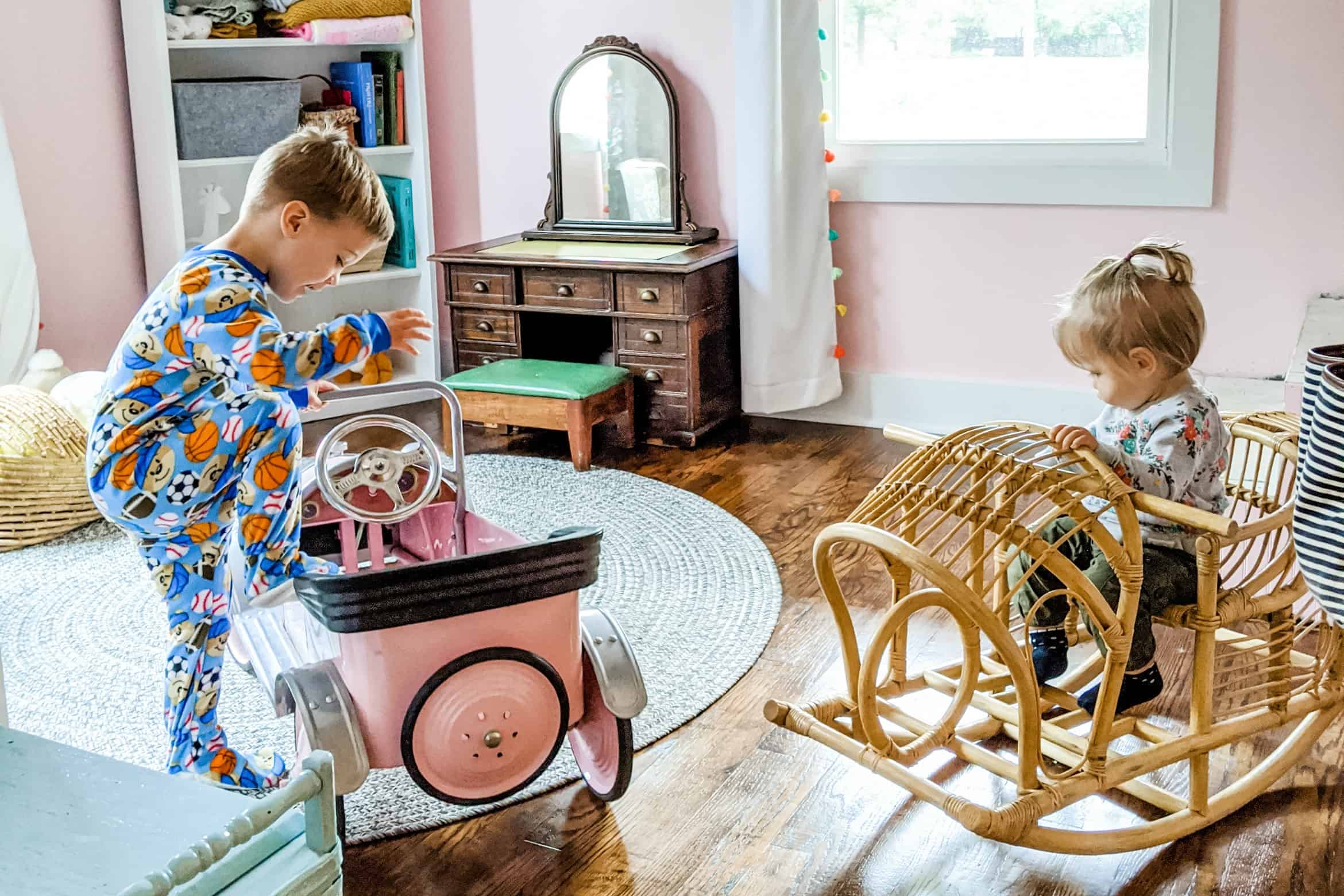 little boy and girl playing with vintage toys in little girls bedroom