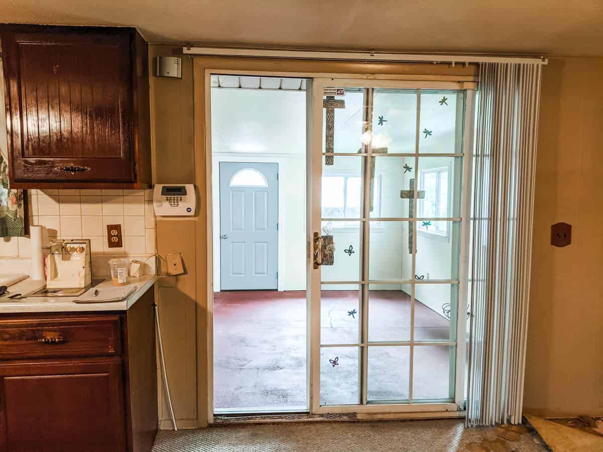 looking at farmhouse kitchen sliding glass door leading into built on back room