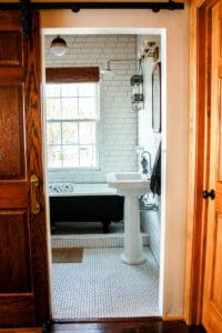 looking into craftsman bungalow bathroom with white black and natural wood accents