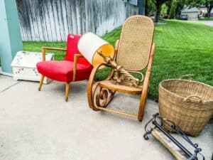 assorted items on the edge of a driveway for sale in a garage sale