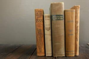 collection of five vintage books in monochromatic shades of taupe orange and brown