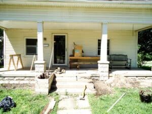bungalow front porch remodel process with dirt work flower bed deconstruction saw horse and tools