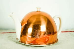 vintage tea pot with copper cozi