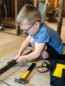 little boy using tools during farmhouse renovation