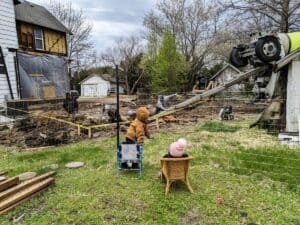 little boy and girl watching construction on 1900s farmhouse renovation
