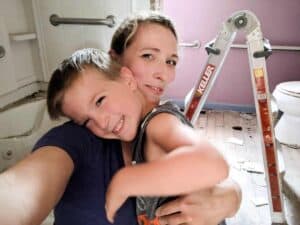 mother and young son renovating farmhouse bathroom