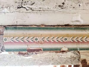 remnants of antique farmhouse wallpapers found during renovation