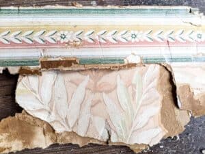 remnants of antique farmhouse floral wallpapers found during renovation
