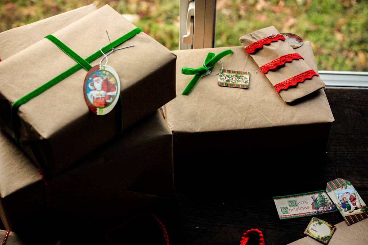 christmas presents wrapped in brown craft paper and vintage ribbons and gift tags