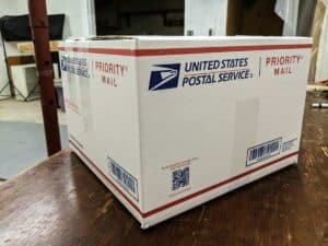 large white usps priority mail box sealed and ready for shipping