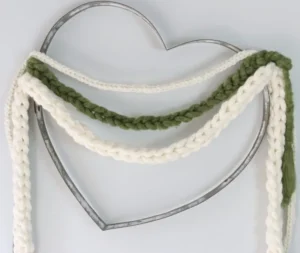 diy finger crocheted yarn garland tied on heart shaped frame