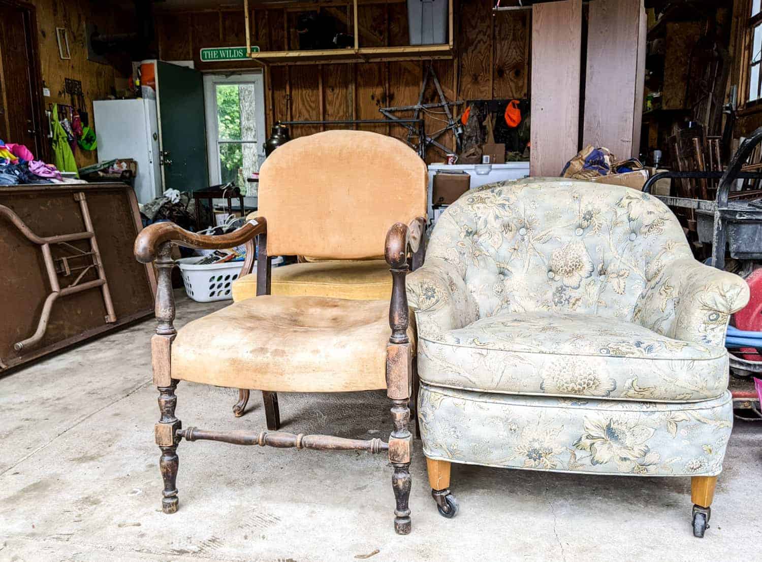 two used chairs displayed in a garage during a garage sale