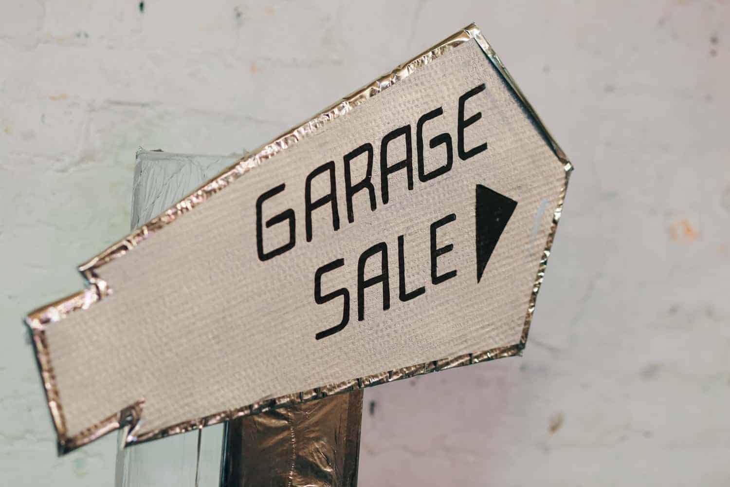 handmade garage sale sign of cardboard and foil