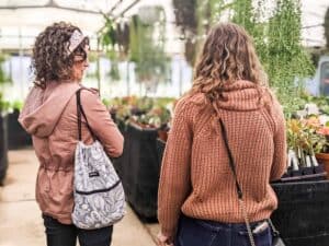mother daughter pair shopping at a plant greenhouse
