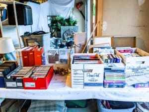 folding table set up in garage with assorted garage sale items arranged for sale